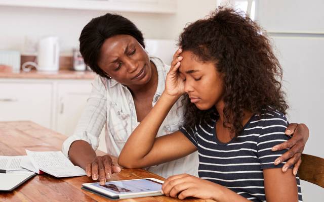 A mother comforting her upset daughter